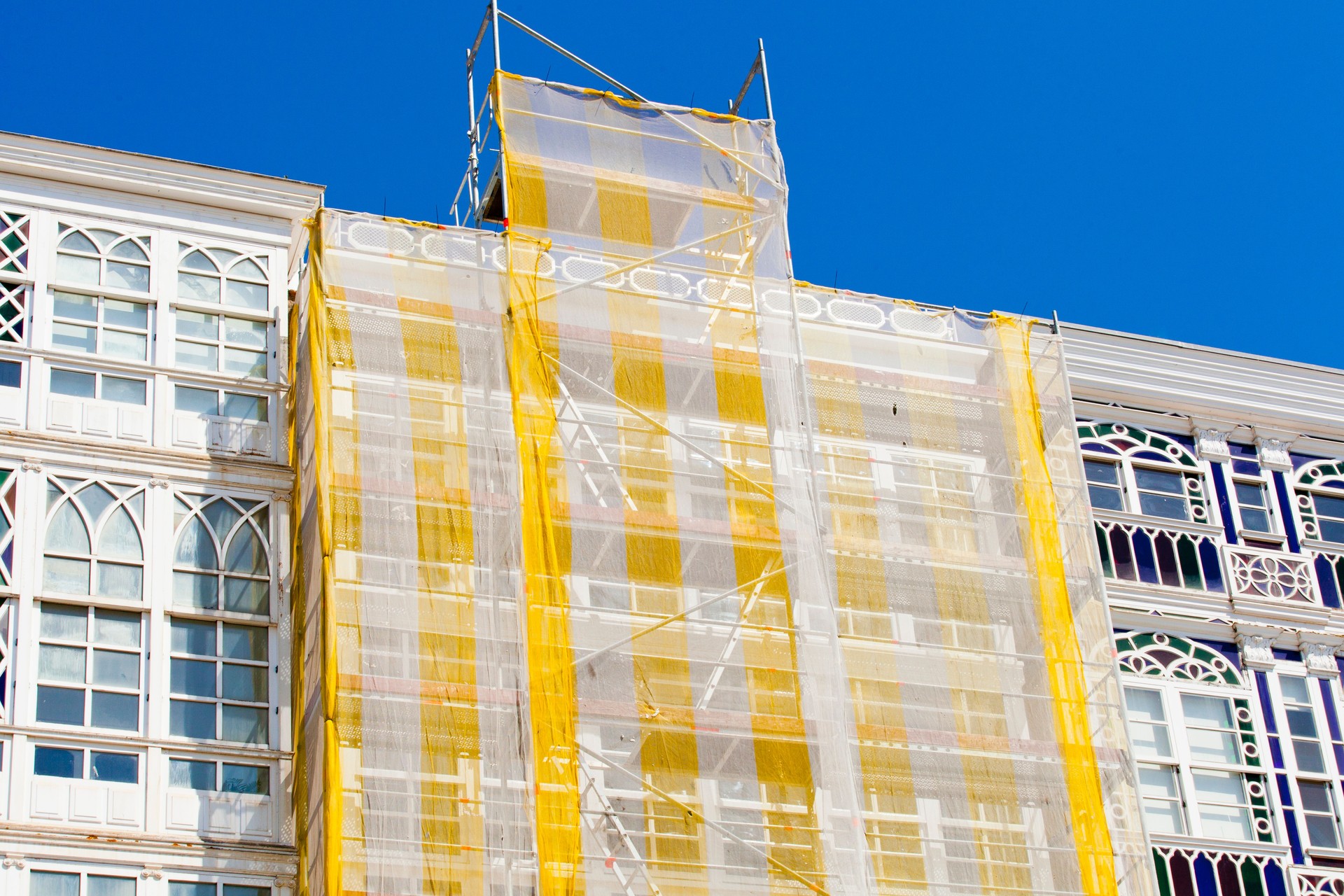 Scaffolding and netting in a restoring construction site.